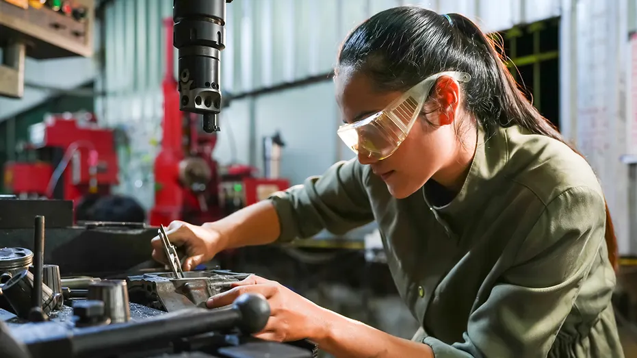 Action d'atelier industriel mécanicien féminin réparant des machines environnement d'usine vue rapprochée pour l'autonomisation